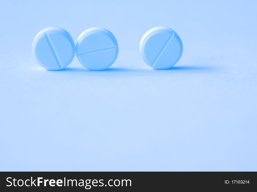 Three tablets on a blue background, creative, close up, blurred