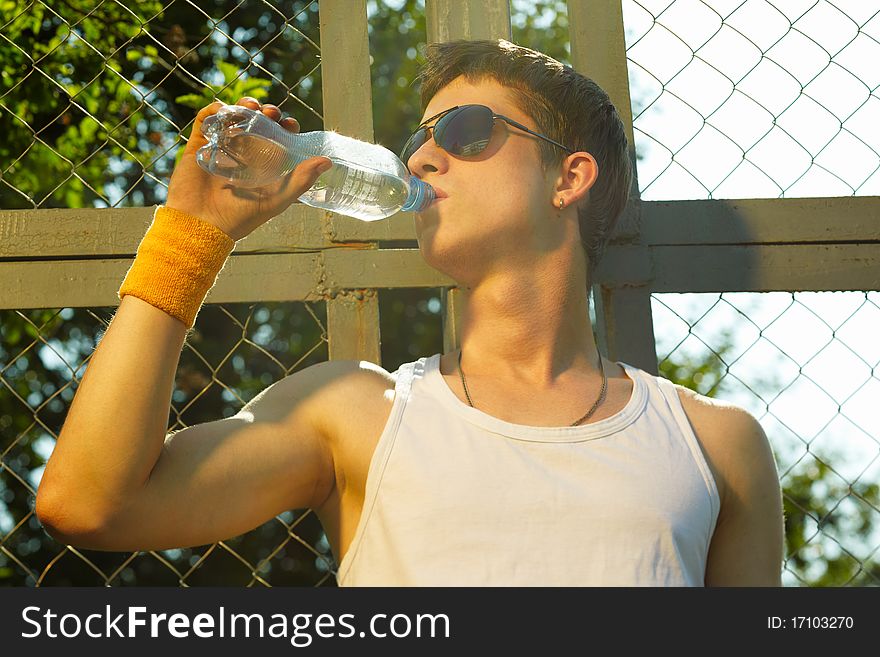 Man is drinking fresh mineral water after sport. Man is drinking fresh mineral water after sport