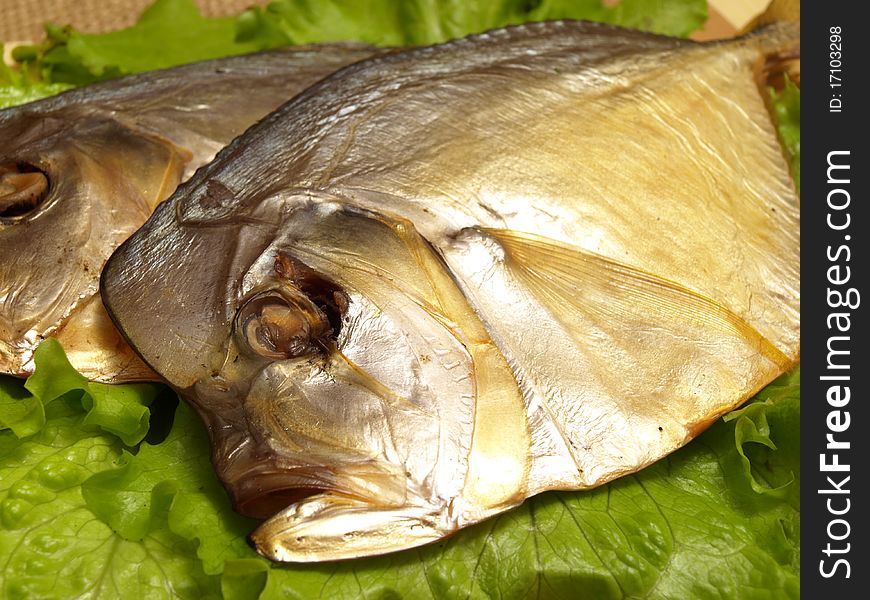 Dorada fish with salad on the white plate. Studio shot
