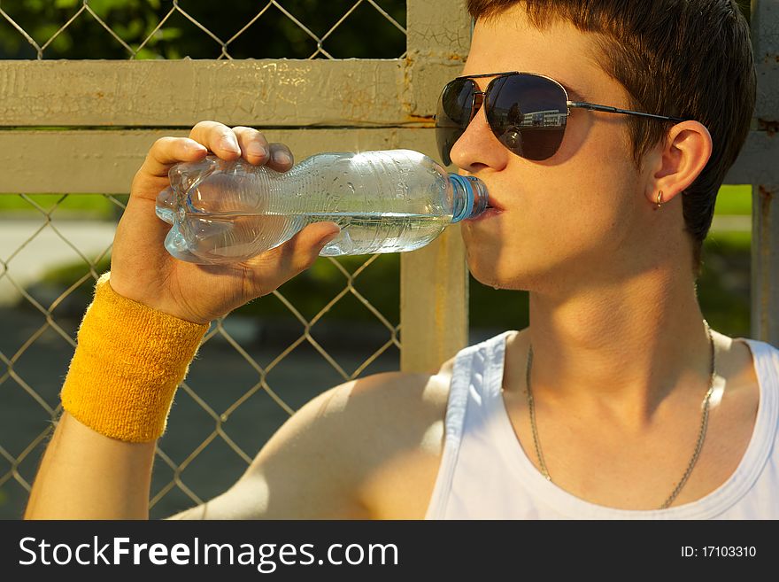 Man is drinking fresh mineral water after sport. Man is drinking fresh mineral water after sport