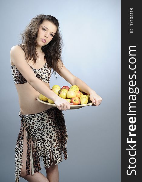 Girl carrying plate with apples and pears. Girl carrying plate with apples and pears