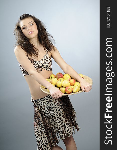 Brunette carrying plate with apples