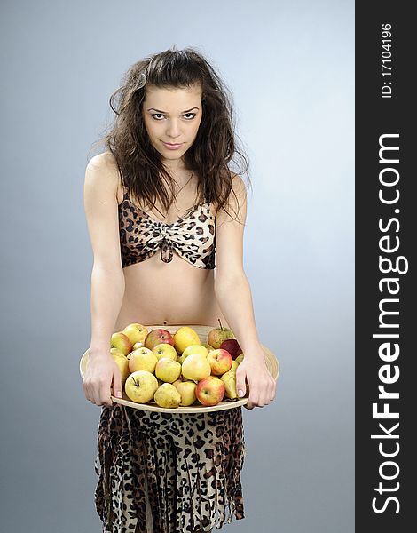 Girl carrying plate with organic apples and pears. Girl carrying plate with organic apples and pears