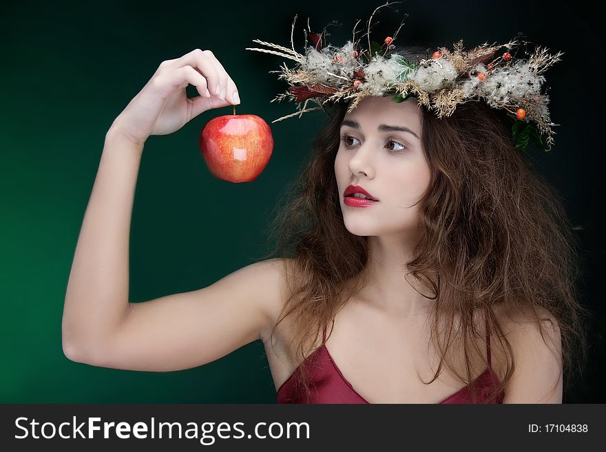Studio shot of young beautiful woman with apple