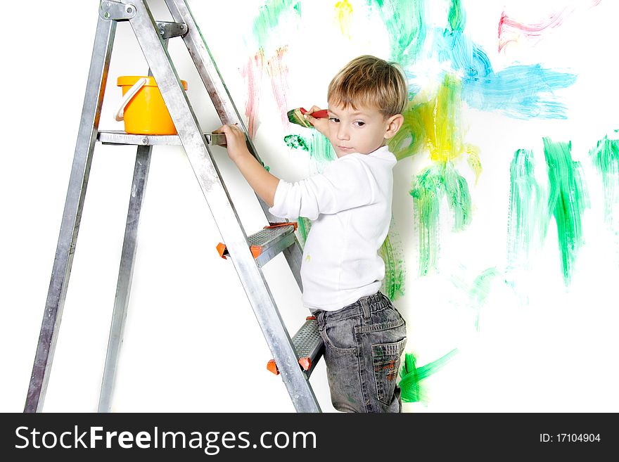 Cute young boy painting over white. Cute young boy painting over white