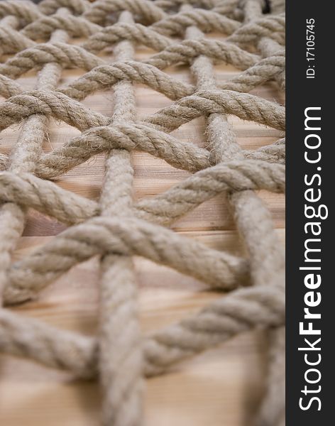 Pattern made of natural rope on plank. Pattern made of natural rope on plank
