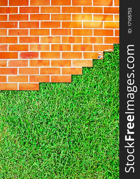 Brick wall fence and grass field