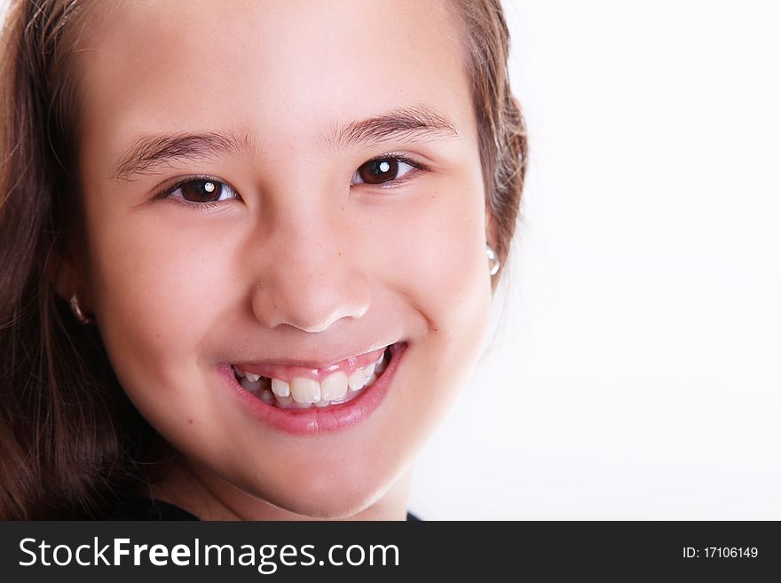 Ten years old girl smiling and looking at the camera, Close up, white background