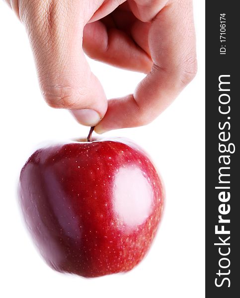 Hand holding a red apple on white background