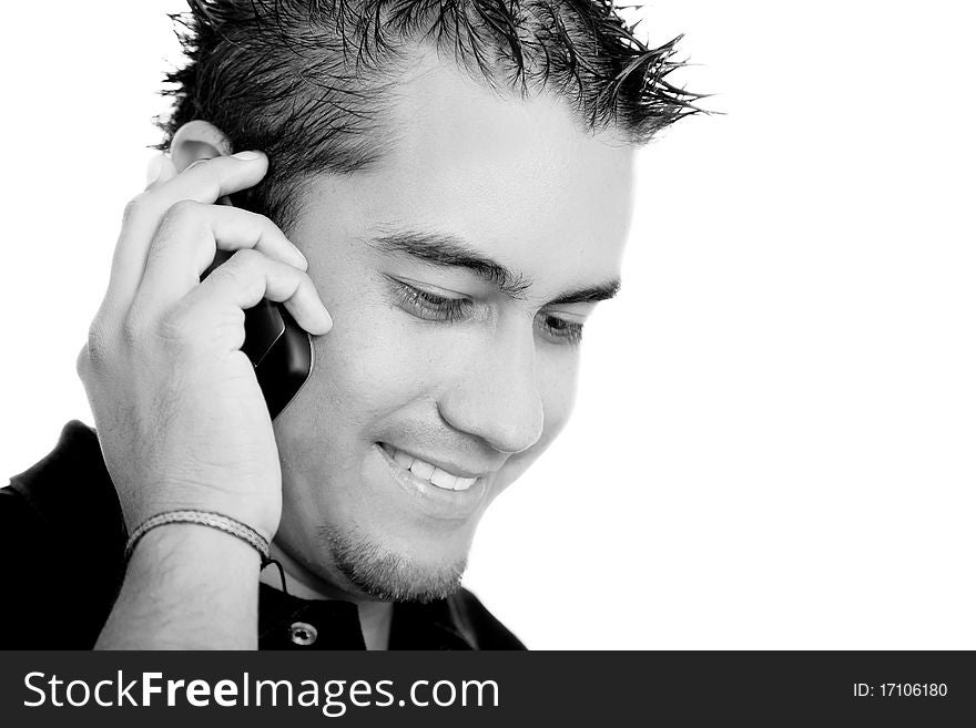 Young man talking on a cell phone on white background, black and white image. Young man talking on a cell phone on white background, black and white image