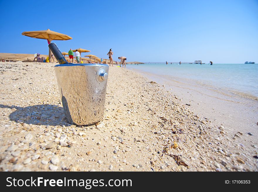 Bottle of wine in a cooler on a tropical beach. Bottle of wine in a cooler on a tropical beach