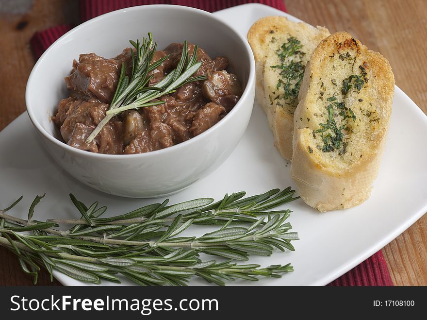 Beef and mushroom casserole with rosemary and garlic bread