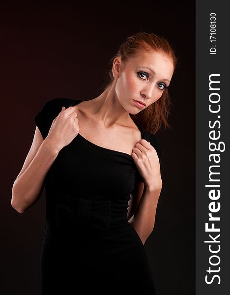 Portrait of a young redhead woman in black dress