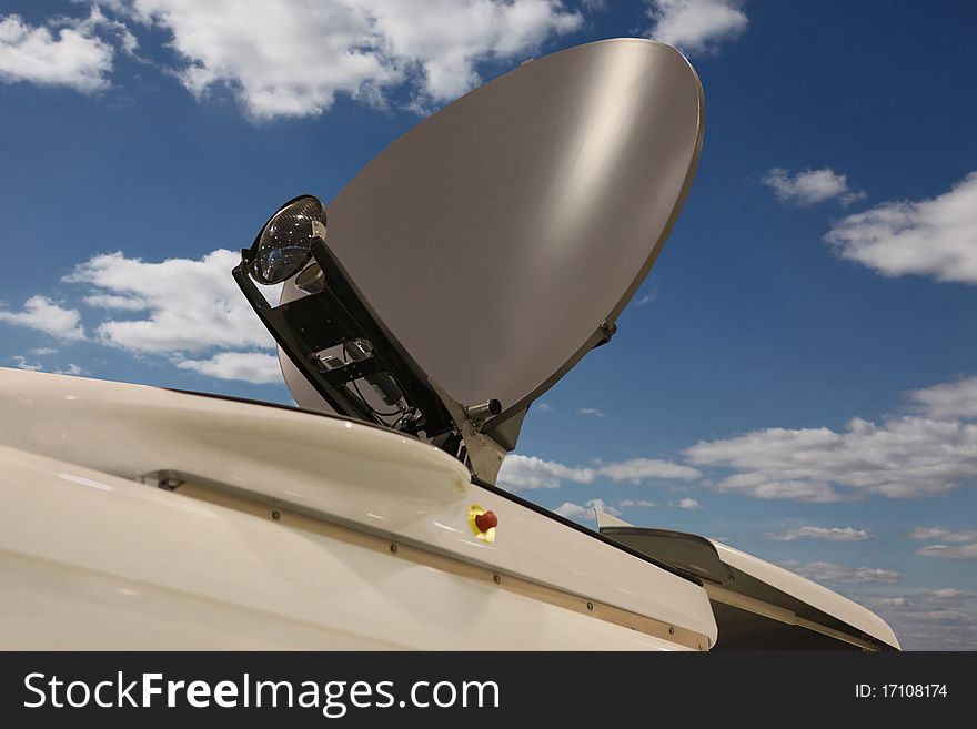 The outer-space communication aerial on a roof of the bus against the cloudy sky. The outer-space communication aerial on a roof of the bus against the cloudy sky