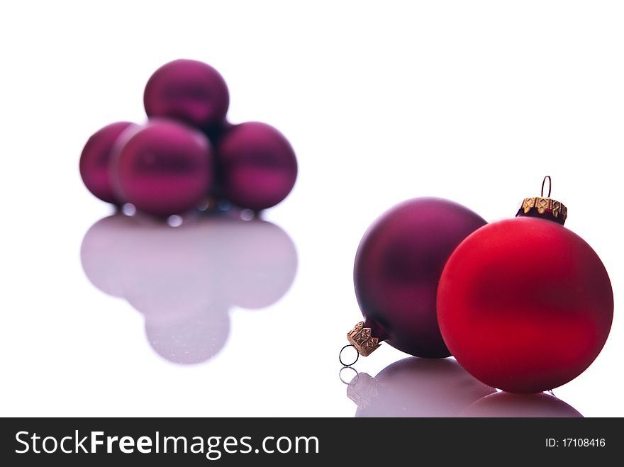 Red and burgund christmas balls on white