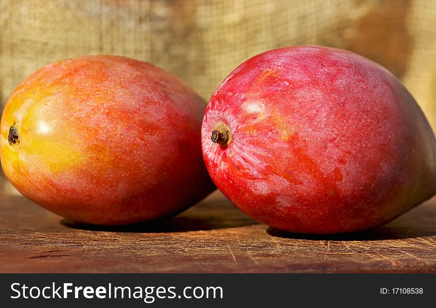 Two red and mature mangoes fruits. Two red and mature mangoes fruits.