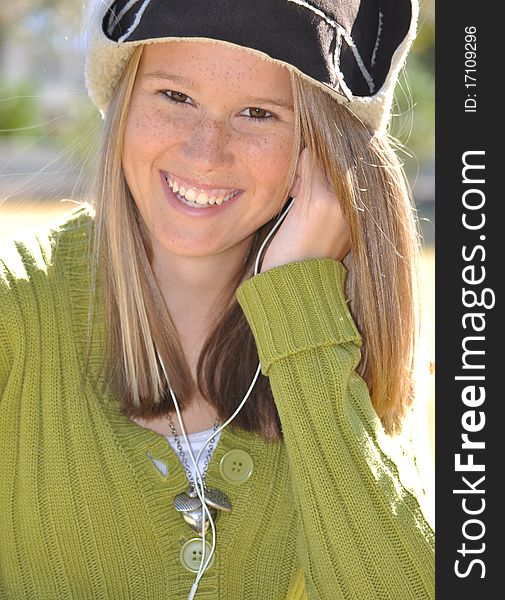 Cute Girl With Winter Wool Hat And Ear Buds