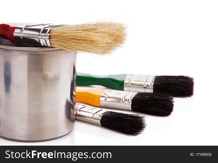 Paint buckets and paintbrush isolated on white