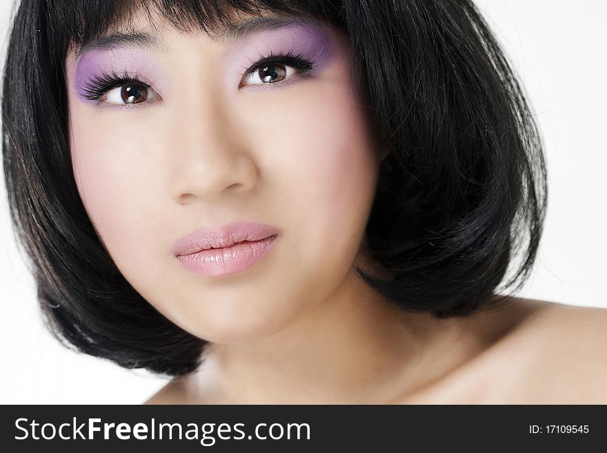 Beautiful asian woman with bright makeup isolated on white background.