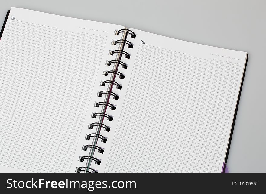 Spiral notebook on grey background