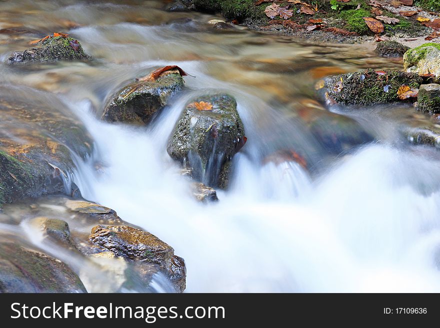 Landscape with mountain stream and cascades