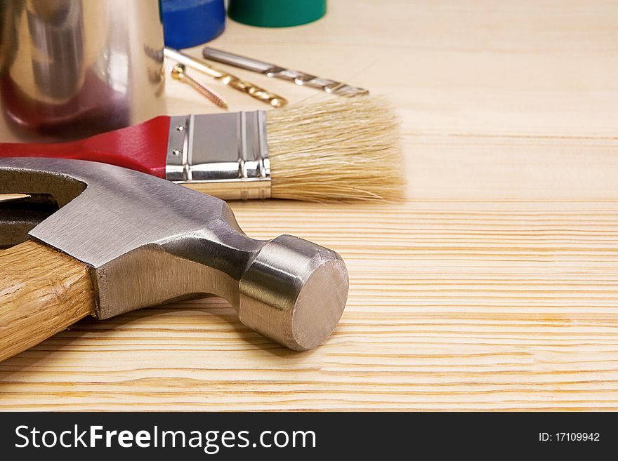 Hammer, Paintbrush And Other Instruments On Wood