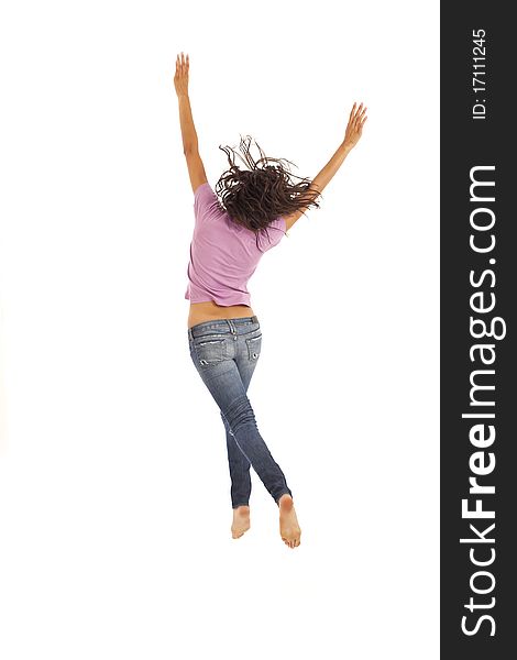 Cute young woman with jeans jumping energetically