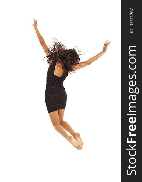 Cute young woman with black dress jumping energetically