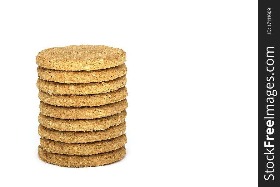 Stack of nine oaty biscuits isolated on white. Stack of nine oaty biscuits isolated on white