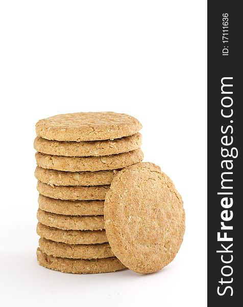 Pile of ten oaty cookies with one leaning against isolated on white. Pile of ten oaty cookies with one leaning against isolated on white