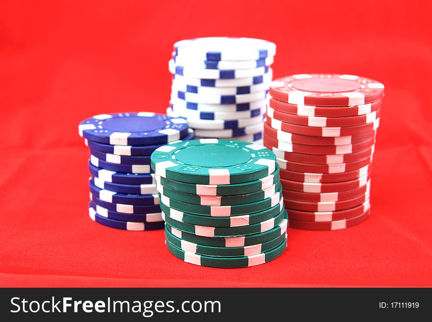 Poker chips for desktop background on red.