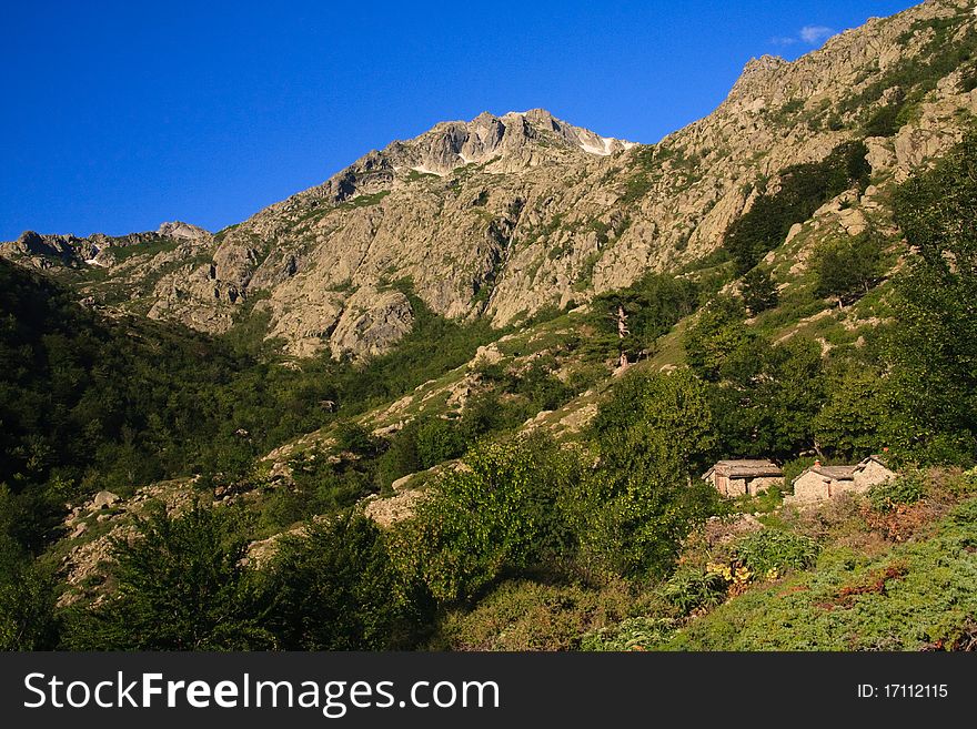 Mountain chalets & trees; Corsica, France