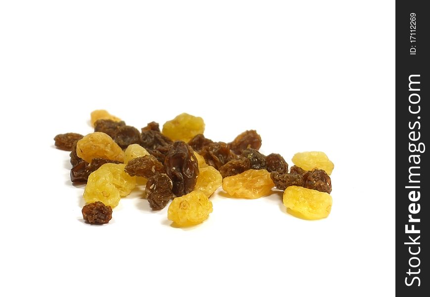 Yellow and brown raisin on the white isolate background. Yellow and brown raisin on the white isolate background