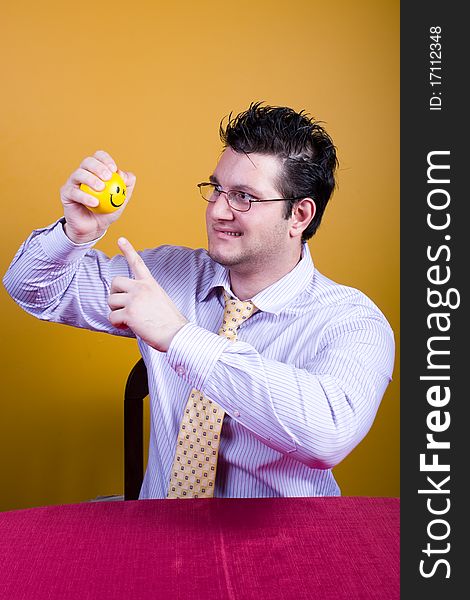 Freaky businessman starring at a tiny relax ball