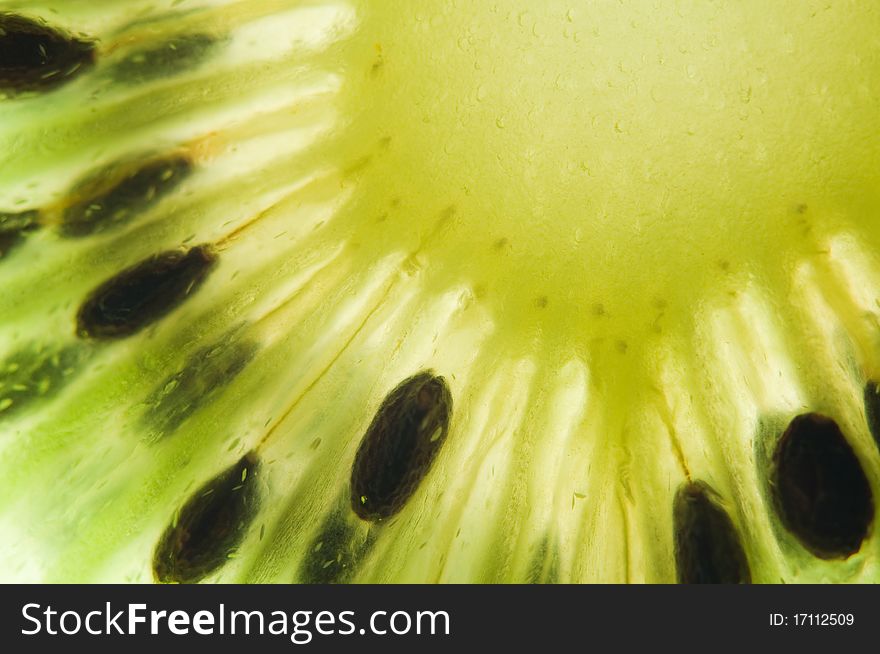 Kiwi slice closeup. Abstract background. Kiwi slice closeup. Abstract background.