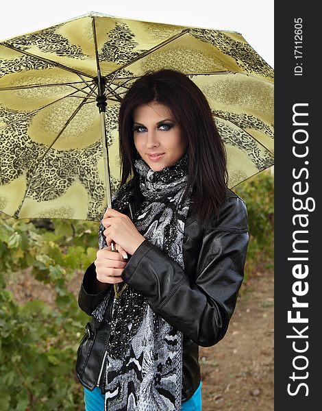 Attractive young girl with green umbrella on floral background. Attractive young girl with green umbrella on floral background