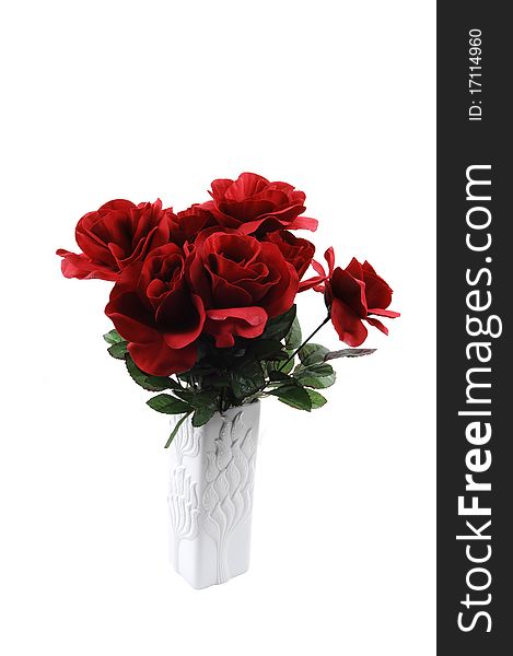 A bunch of red silk roses in a white vase for white background. A bunch of red silk roses in a white vase for white background.