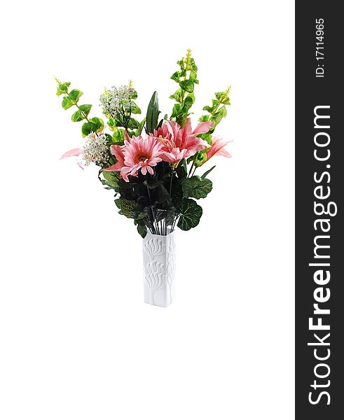 A nice bunch of silk lilies with some green branches in a white vase for white background. A nice bunch of silk lilies with some green branches in a white vase for white background.