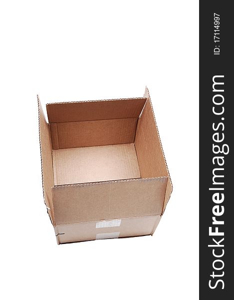 An empty used brown cardboard box sitting on white background with copy space. An empty used brown cardboard box sitting on white background with copy space.