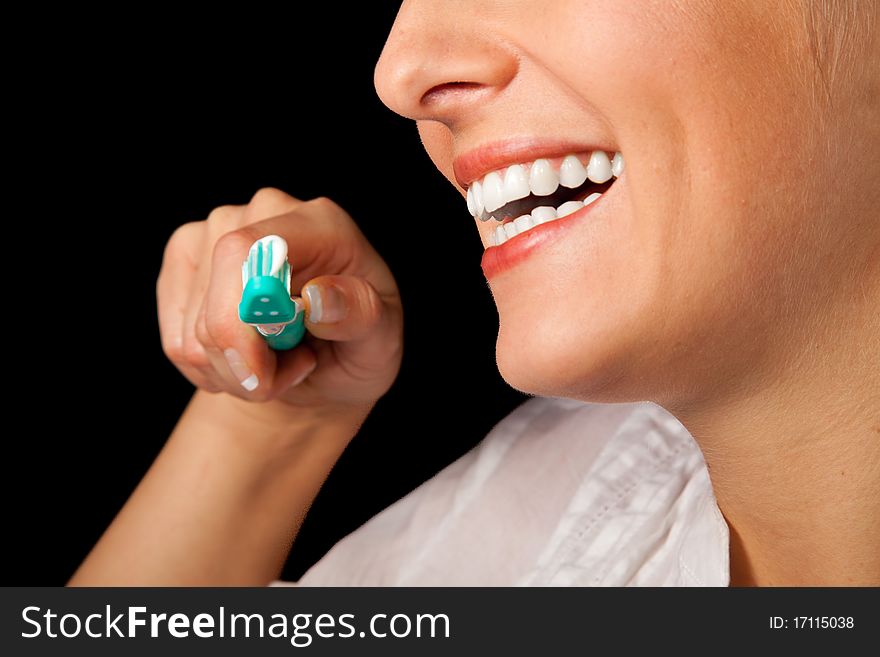 Woman healthy teeth closeup with toothbrush on black background. Woman healthy teeth closeup with toothbrush on black background