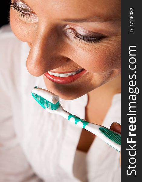 Woman healthy teeth closeup with toothbrush on black background. Woman healthy teeth closeup with toothbrush on black background