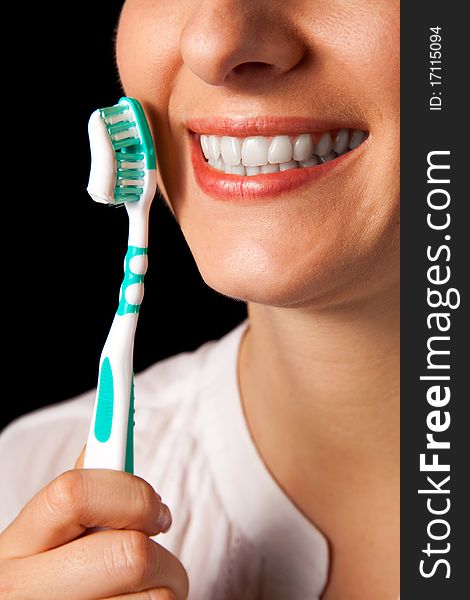 Woman healthy teeth closeup with toothbrush on black background. Woman healthy teeth closeup with toothbrush on black background