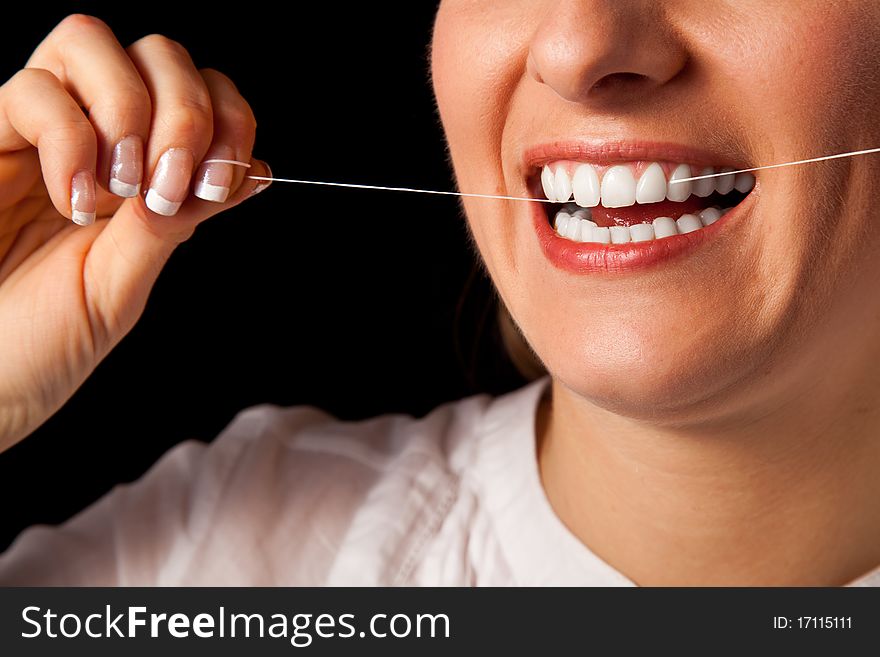 Woman healthy teeth closeup with toothbrush on black background. Woman healthy teeth closeup with toothbrush on black background