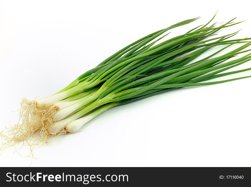 Fresh, organic leeks on white background.