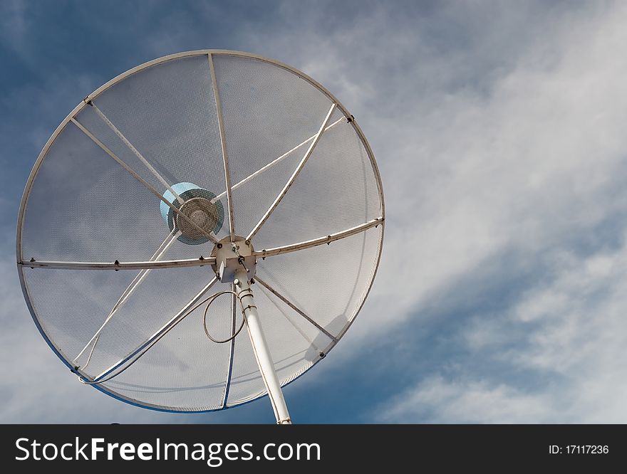 Detail of white satellite over blue sky