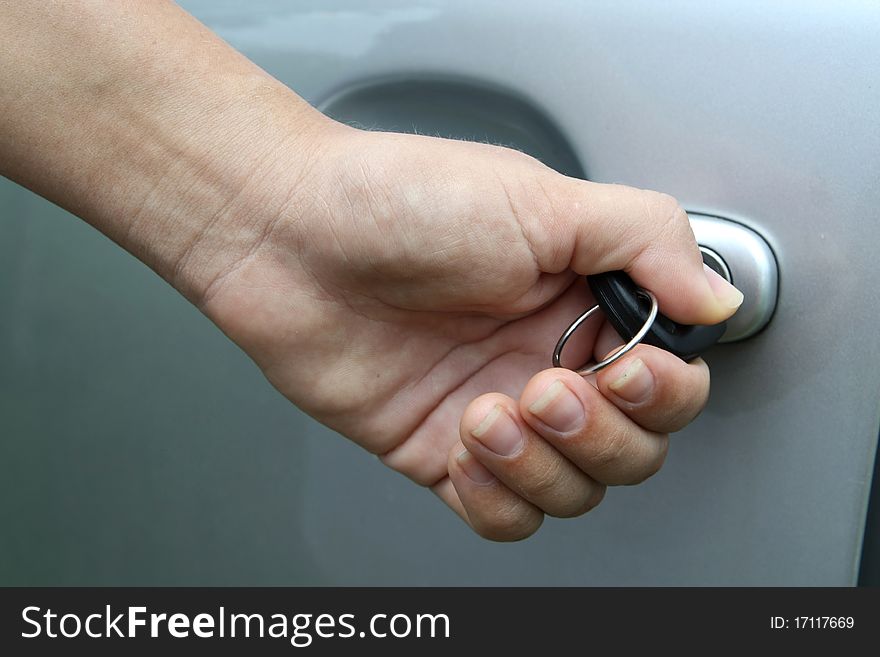 Young women open shes silver car, photo taken for new cars commercial