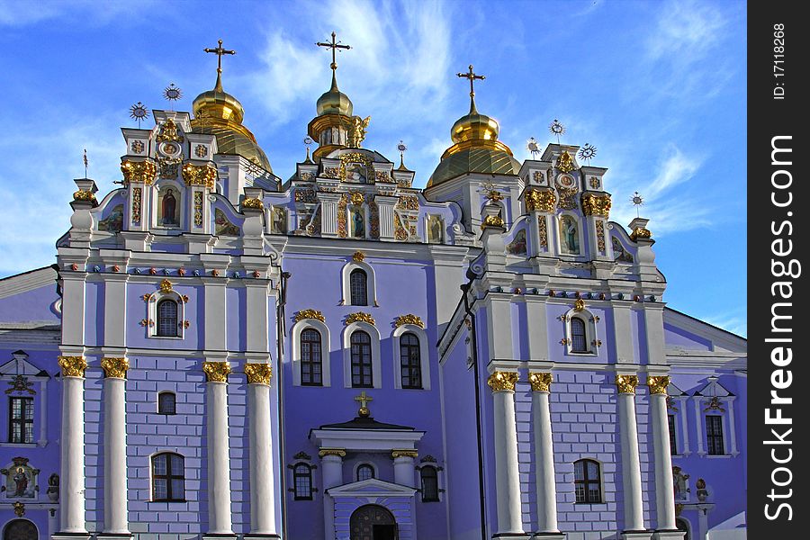 Blue cathedral with gold domes against the sky. Blue cathedral with gold domes against the sky