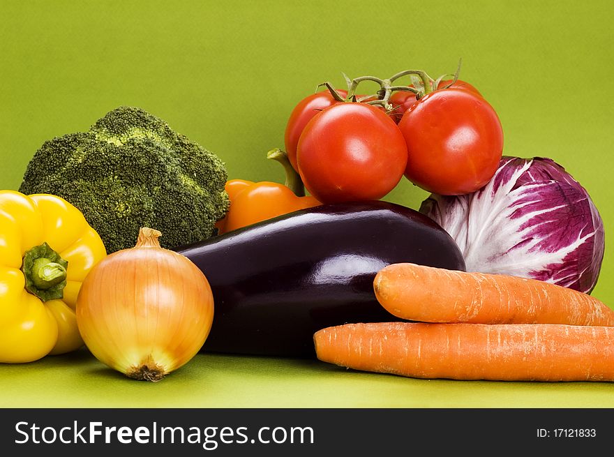 Fresh vegetables on green background