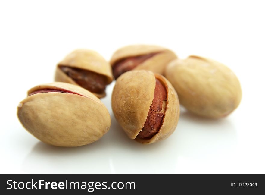 Dried pistachios on a white background