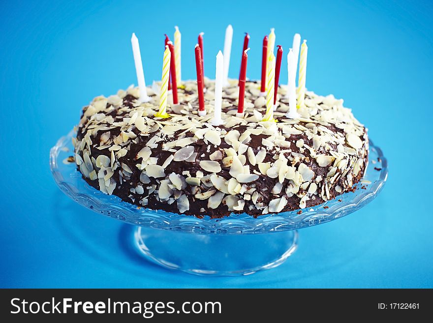 Chocolate birthday cake with flaked almonds and candles